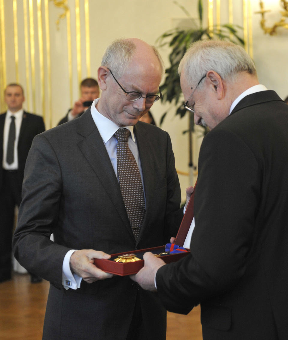 Slovakian President Ivan Gasparovic, right, hands the Order of the White Double Cross, a high Slovak state decoration, to European President Herman Van Rompuy, left, at the occasion of the 10th anniversary of the Slovakian entrance into EU in Bratislava, Slovakia, Wednesday, April 30, 2014. (AP Photo,CTK/Jan Koller) SLOVAKIA OUT