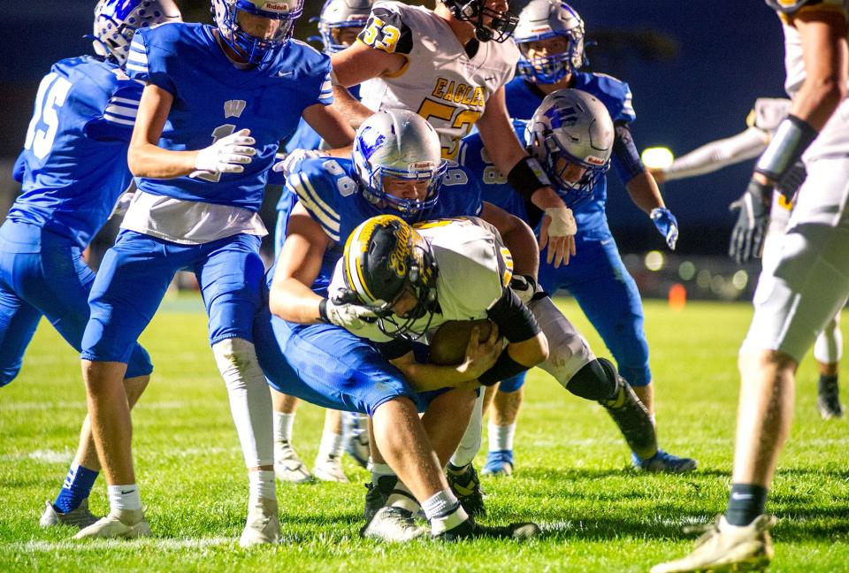 Colonel Crawford's Tanner Dyer pushes through Wynford's Kalen Skidmore for a touchdown.