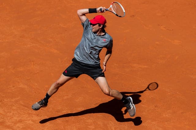 Dominic Thiem hits a forehand against Alex De Minaur