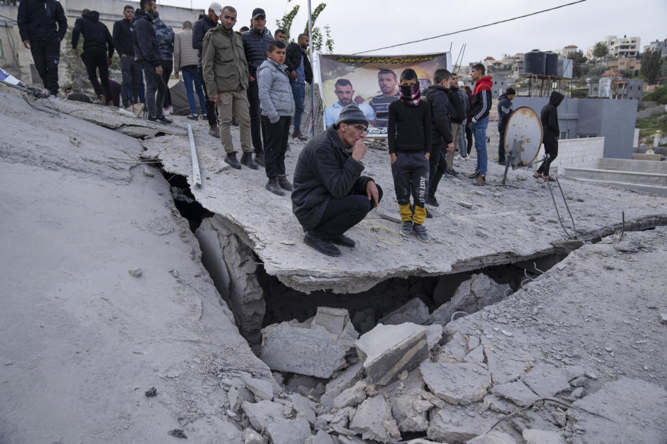 Palestinians inspect the site of a house that was demolished by the Israeli army in the West Bank village of Kafr Dan, near Jenin, Monday, Jan. 2, 2023. Palestinians Samer Houshiyeh and Fouad Abed were shot and killed during clashes with the Israeli army in the village of Kafr Dan near the northern city of Jenin. The Israeli military said it entered Kafr Dan late Sunday to demolish the houses of two Palestinian gunmen who killed an Israeli soldier during a firefight in September. The military said troops came under heavy fire and fired back at the shooters. (AP Photo/Nasser Nasser)