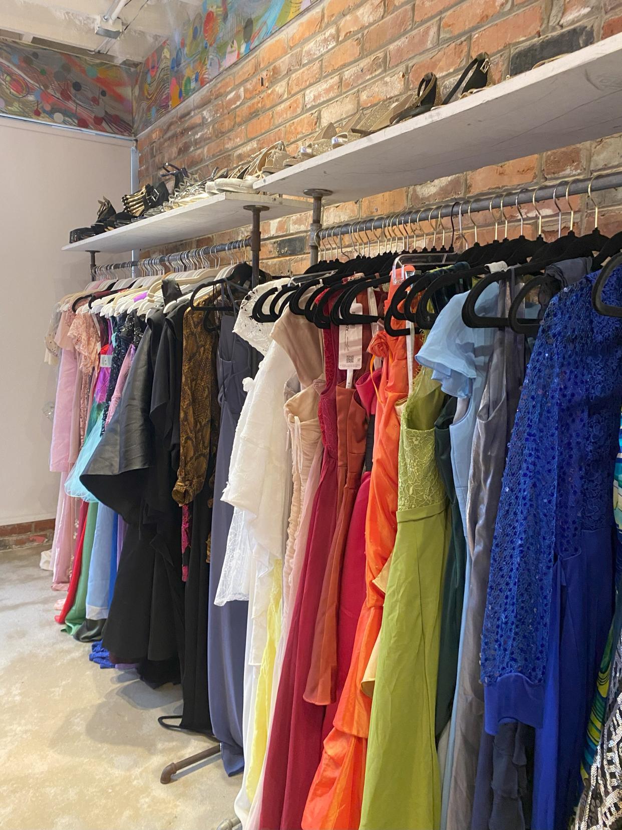 Racks of ballgowns donated to Race to the Prom dress giveaway pop-up shop at Vantosh Realty