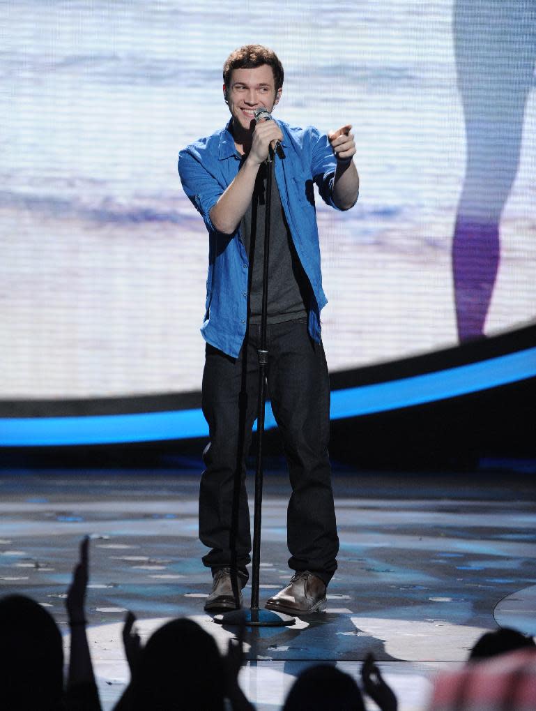 FILE - In this May 9, 2012 file photo provided by Fox, contestant Phillip Phillips performs on the singing competition series "American Idol," in Los Angeles. With the eleventh season finale of "American Idol" just a week away, many fans of the Fox talent contest aren't wondering who will capture the title, but whether sassy 16-year-old diva-in-training Jessica Sanchez or booming 20-year-old vocal showstopper Joshua Ledet would even have the votes to beat bluesy 21-year-old front-runner Phillip Phillips. (AP Photo/Fox, Michael Becker, File)