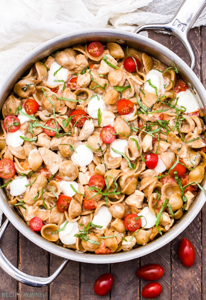 Caprese Chicken Pasta cooking in a large pan