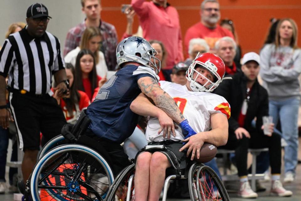 Kansas City Chiefs player Clayton Peters (0) catches a pass while being guarded by Dallas Cowboys player Zack Ruhl, left, during the USA Wheelchair Football League Championship, a program of Move United, Tuesday, Feb. 6, 2024 in Dallas, Texas.