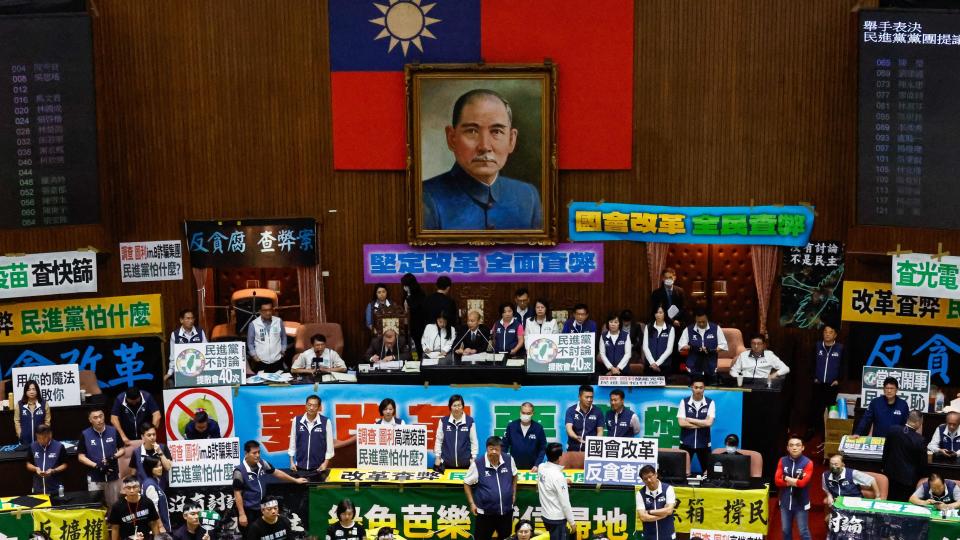 Taiwanese lawmakers holding placards chant slogans, at the chamber inside the Legislative Yuan, in Taipei, Taiwan, 28 May 2024. 