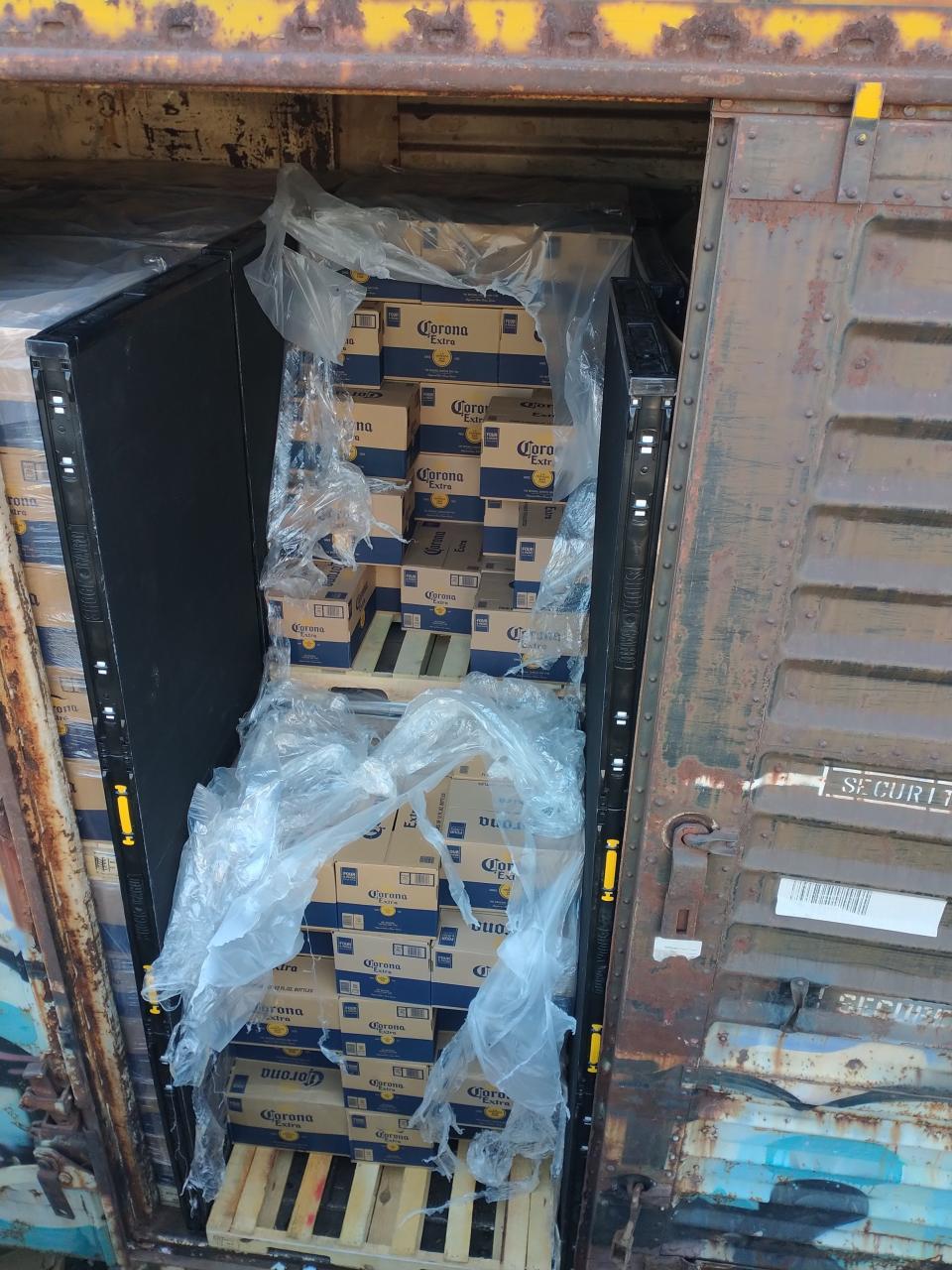 Cases of beer sit in an open container on tracks in the Lincoln Heights neighborhood of Los Angeles, where dozens of similar cargo containers have been looted in recent months.