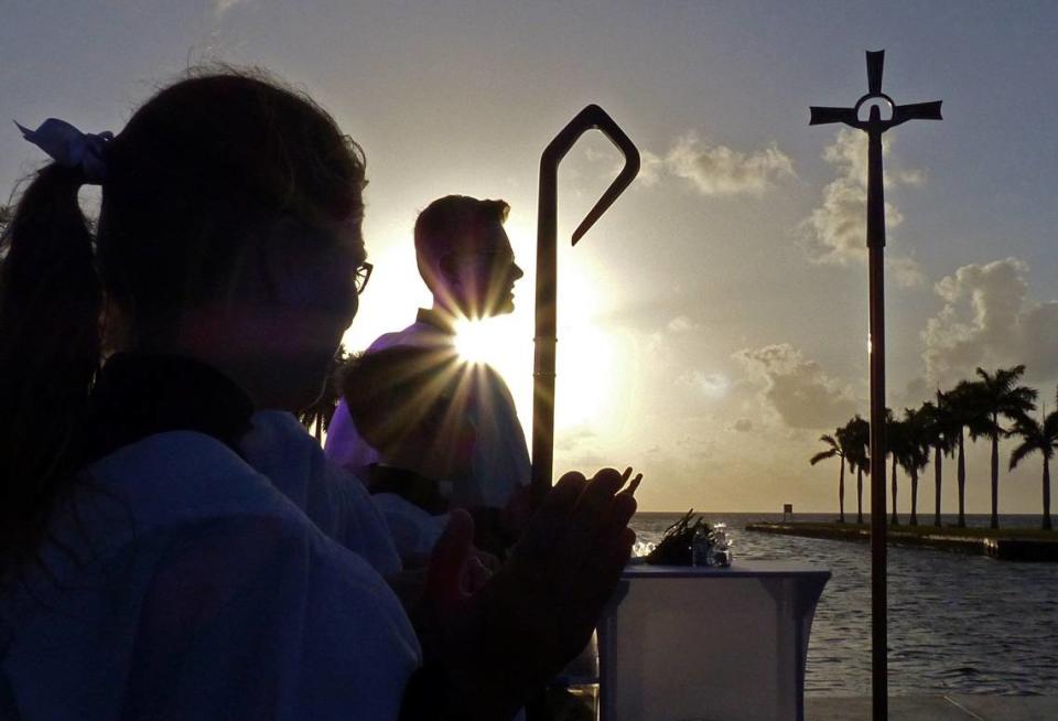 The sun rises behind servers during Holy Rosary St. Richard Catholic Church’s Easter Sunrise service at the Charles Deering Estate in Palmetto Bay in 2019. Due to the coronavirus, the 2020 sunrise service at Deering is canceled and the church will livestream its service.