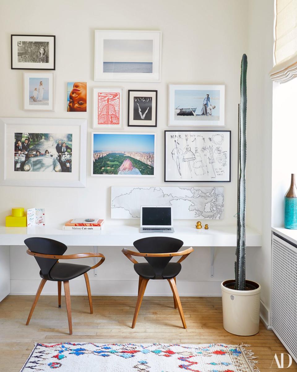 The home office features a gallery wall with a mix of work from Melling’s friends and colleagues. “It’s more a personal collection than it is a collector’s collection,” she says. “When I was leaving my old space I had a lot of things that weren’t framed, but I wanted to preserve them.” Also encased in glass, just out of view, is her husband’s taxidermy bird (“from his first hunting trip”) which elicits a more muted response. “As a designer, I don’t like fake accessories—so if it’s something that means something to someone then I think it works better,” says Ariel Ashe, who designed the space.