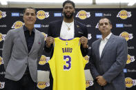 Los Angeles Lakers NBA basketball team general manager Rob Pelinka, left, and Head Coach Frank Vogel, right, introduce Anthony Davis at a news conference at the UCLA Health Training Center in El Segundo, Calif., Saturday, July 13, 2019 (AP Photo/Damian Dovarganes)