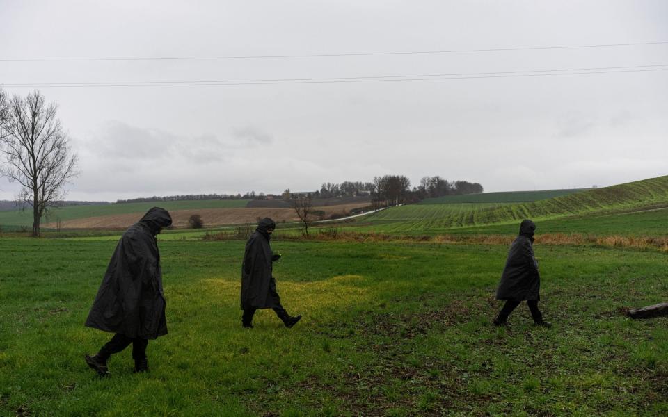 Polish police officers search for missile wreckage in the field, near the place where a missile struck, killing two people in a farmland at the Polish village of Przewodow