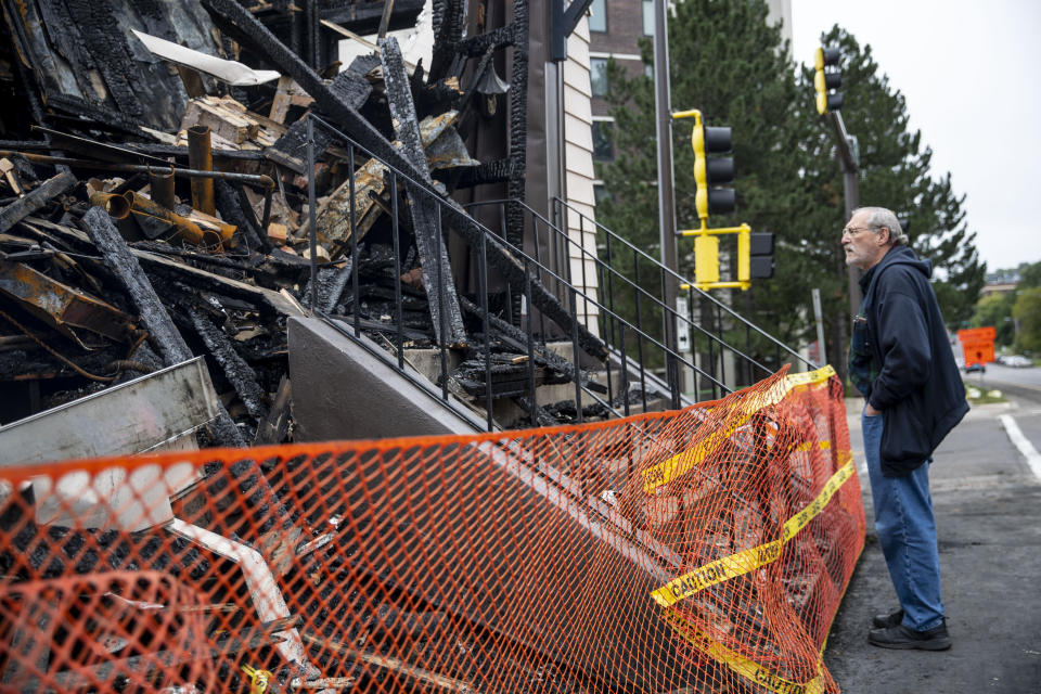 Sam Pomush, whose grandfather helped found the Adas Israel Synagogug took a walk around the building Sunday September 15, 2019. The fire that destroyed the historic synagogue doesn't appear to have been a hate crime, authorities said Sunday in discussing the arrest of a suspect. A suspected was arrested last week and will be charged with first degree arson. (Alex Kormann/Star Tribune via AP)/Star Tribune via AP)
