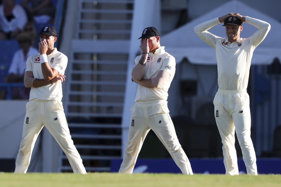 From left to right, England players James Anderson, Ben Stokes and Jos Buttler gesture during day one of the second Test cricket match against West Indies at the Sir Vivian Richards Stadium in North Sound, Antigua and Barbuda, Thursday, Jan. 31, 2019. (AP Photo/Ricardo Mazalan)