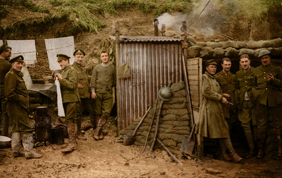 <p>This photograph shows a group of soldiers standing in the entrance to a dugout. Other men are outside, standing beside a washing line with towels on it. A pot is steaming on a brazier made of a tin drum. This rather domestic scene appears well removed from the reality of the trenches at the Front. It may have been intended to counter criticism of the campaign by implying that it was better organised than was the case. (Tom Marshall/mediadrumworld.com) </p>