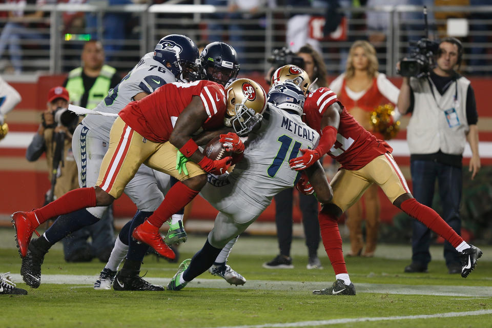 Jaquiski Tartt (29) of the San Francisco 49ers strips the ball from D.K. Metcalf of the Seattle Seahawks. (Photo by Lachlan Cunningham/Getty Images)