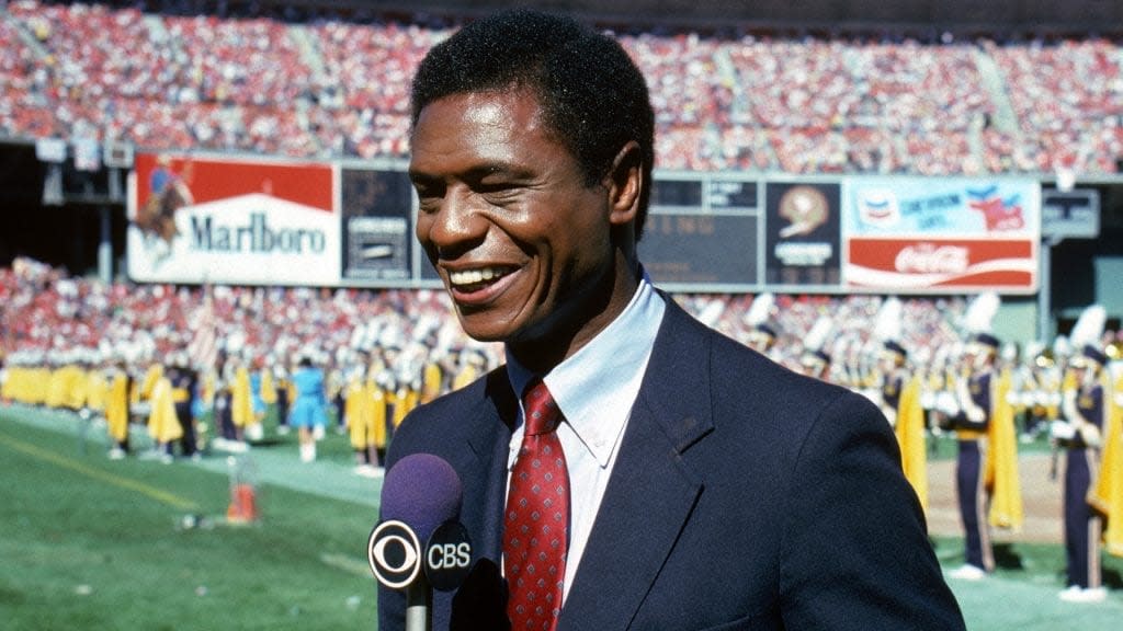 In this 1985 photo, CBS Football analyst Irv Cross talks through the on-the-field antics during a season game. Cross, a former NFL cornerback, has died at age of 81. (Photo by George Rose/Getty Images)