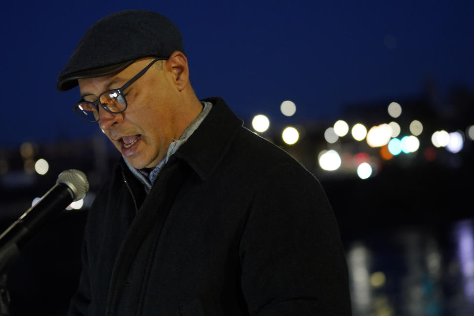 Auburn, Maine Mayor Jason Levesque reads the names of those killed in the Lewiston shootings to community members gathered, Thursday, Nov. 2, 2023, during a candlelight vigil in Auburn, Maine. Locals seek a return to normalcy after a mass shooting in Lewiston on Oct. 25. (AP Photo/Matt York)