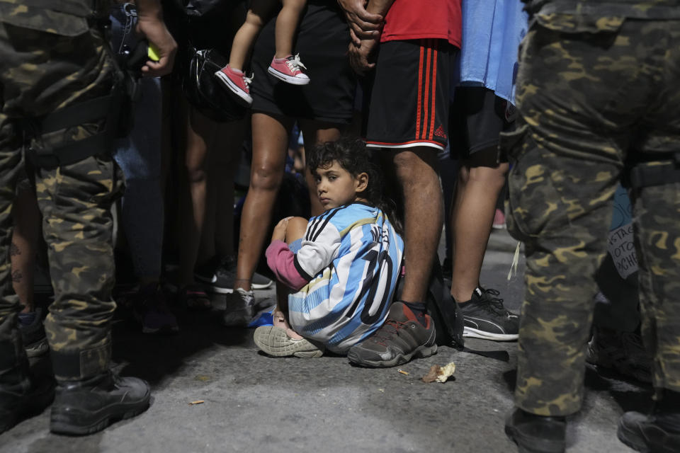 Fans waits for the arrival of the Argentine soccer team that won the World Cup outside the AFA training grounds in Buenos Aires, Argentina, Tuesday, Dec. 20, 2022. (AP Photo/Matilde Campodonico)