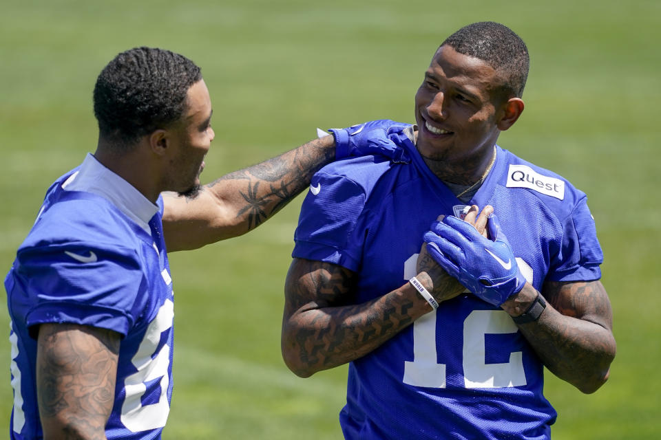 New York Giants tight end Darren Waller (12) walks off the field with Lawrence Cager (83) after workouts at the NFL football team's practice facility, Thursday, May 25, 2023, in East Rutherford, N.J. (AP Photo/John Minchillo)