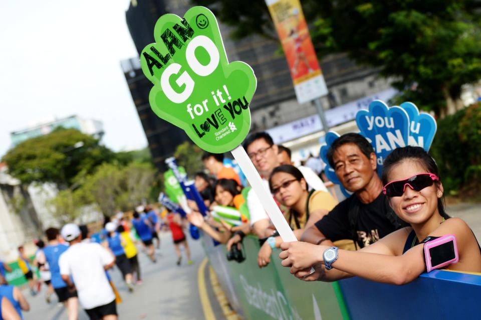 Supporters with their customised cheering boards (Photo courtesy of Singapore Sports Council)