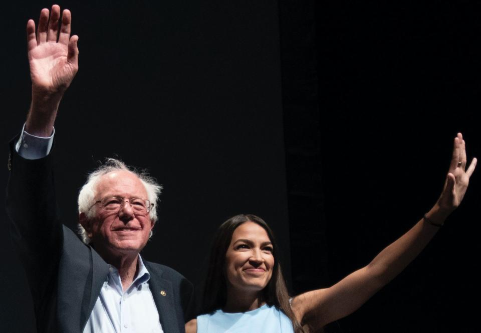 James Thompson, Senator Bernie Sanders and Alexandria Ocasio-Cortez, wave to the crowd at the end of a campaign rally in Wichita, Kansas on July 20, 2018. (Photo: J Pat Carter for the Washington Post via Getty)