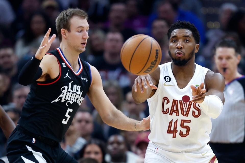 Cleveland Cavaliers guard Donovan Mitchell (45) passes against Los Angeles Clippers guard Luke Kennard (5) during the first half of an NBA basketball game, Sunday, Jan. 29, 2023, in Cleveland. (AP Photo/Ron Schwane)