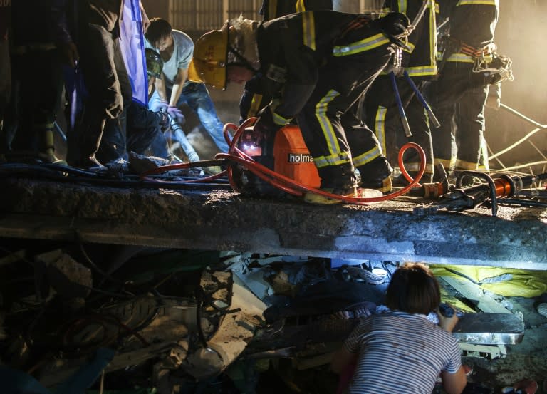 This photo taken on July 4, 2015 shows rescuers looking for survivors in the debris of a collapsed building in Wenling, east China's Zhejiang province