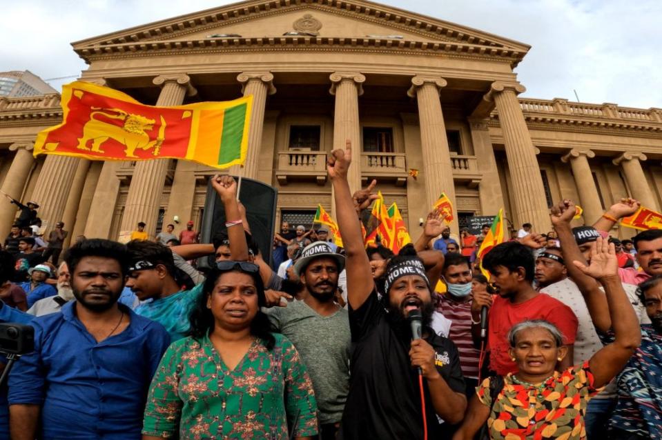 Sri Lankan anti-government protestors shout and wave flags in front of the president's office in Colombo, Sri Lanka, on July 20, 2022.