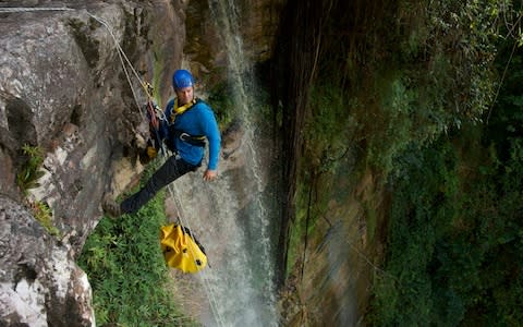 Backshall's new TV series sees him travelling to unexplored locations- here, abseiling in Suriname, South America - Credit: Graham MacFarlane
