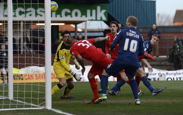 Oldham Athletic's Matt Smith (R) scores against Liverpool in the FA Cup fourth round at Boundary Park on January 27, 2013. Oldham, three-time semi-finallists, joined fellow third-tier side Milton Keynes Dons, Championship clubs Millwall and Leeds United, and non-league Luton Town in claiming a famous Premier League scalp