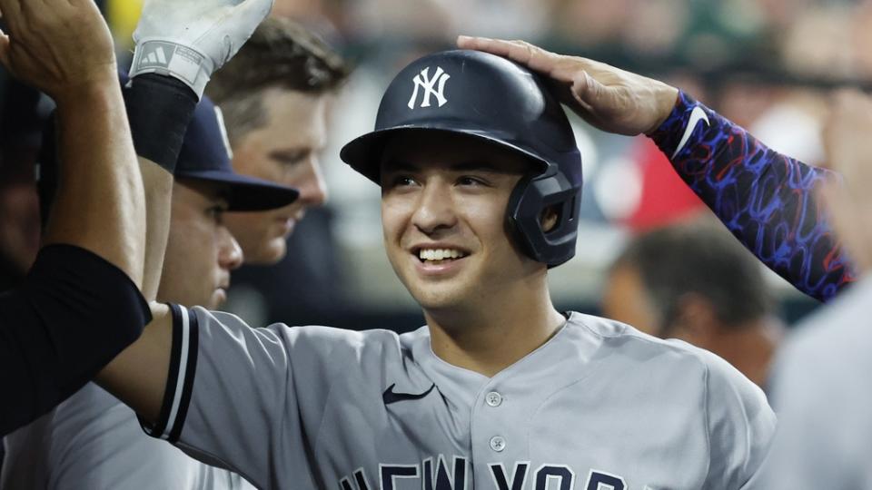 New York Yankees shortstop Anthony Volpe (11) celebrates with teammates after hitting a home run in the ninth inning against the Detroit Tigers at Comerica Park.