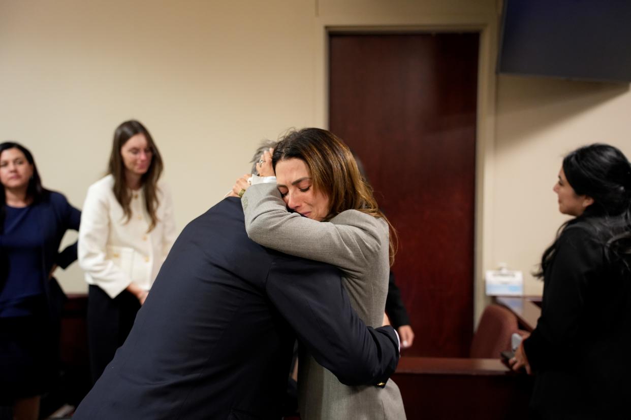 Hilaria Baldwin embraces her husband Alec Baldwin after his manslaughter case is dismissed. 