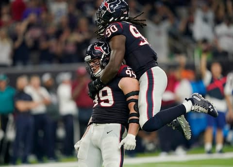 Houston Texans defensive end J.J. Watt (99) and linebacker Jadeveon Clowney (90) celebrate a stop against the Dallas Cowboys during the second half of an NFL football game in Houston - Credit: AP Photo/David J. Phillip