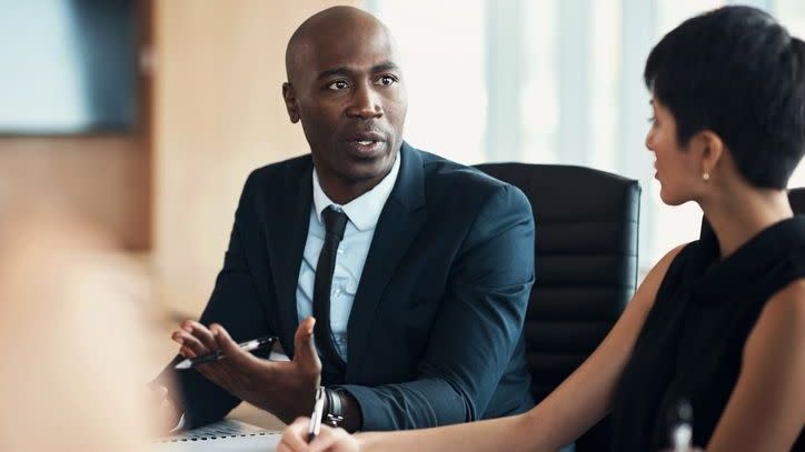 A financial advisor who's considered an exempt reporting adviser (ERA) speaks during a business meeting.