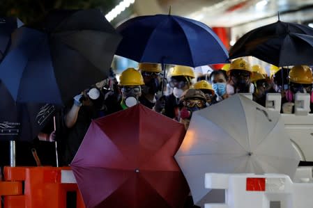 Anti-extradition bill protesters hold umbrellas during a march in Hong Kong