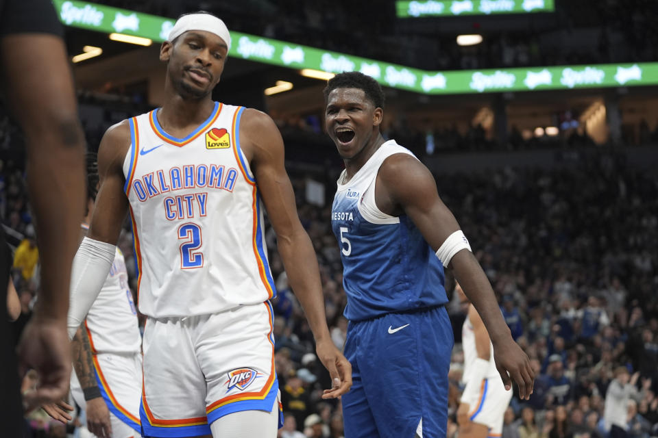 Minnesota Timberwolves guard Anthony Edwards (5) celebrates next to Oklahoma City Thunder guard Shai Gilgeous-Alexander (2) after making a basket and being fouled during the first half of an NBA basketball game Saturday, Jan. 20, 2024, in Minneapolis. (AP Photo/Abbie Parr)