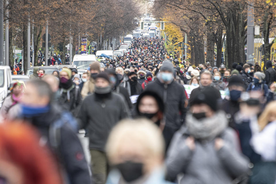 Protestors attend a so called 'silent march' against the corona policy of the federal government at the district Prenzlauer Berg in Berlin Germany, Sunday, Nov. 22, 2020. (Fabian Sommer/dpa via AP)