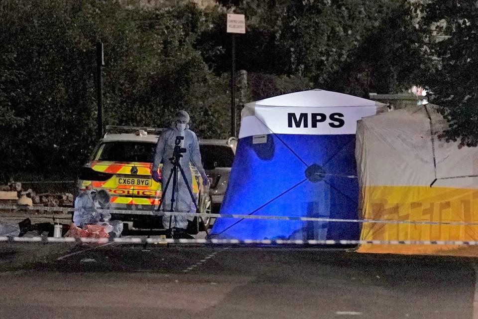 Forensics officers at the scene of the stabbing (PA)