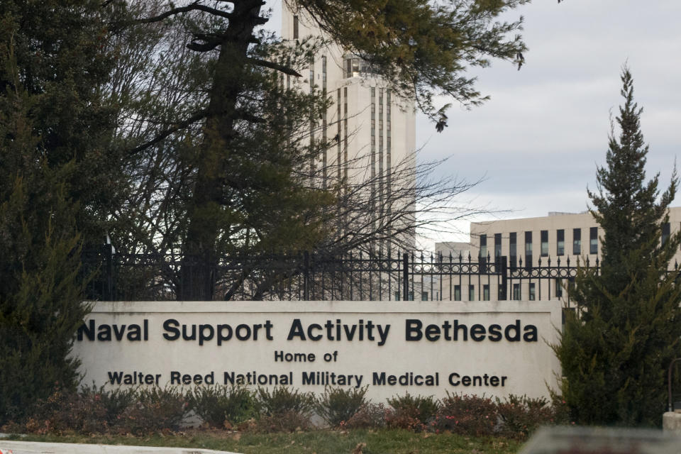 FILE - An sign stands near an entrance to Walter Reed National Military Medical Center on Tuesday, Nov. 27, 2018, in Bethesda, Md. The management of the medical center has drawn criticism from a prominent archbishop - and some members of Congress - by choosing not to renew a contract for Franciscan priests to provide pastoral care, and by hiring a hiring a secular defense contractor, Mack Global LLC, to oversee provision of those services going forward. Walter Reed said it notified the Franciscans in March 2023 that their contract would not be renewed. (AP Photo/Carolyn Kaster, File)