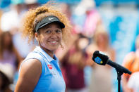 <p>A smiling Naomi Osaka gets chatty on Aug. 18 during the 2021 Western & Southern Open WTA 1000 tennis tournament near Cincinnati, Ohio.</p>