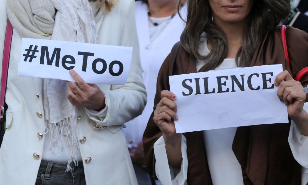 A woman holds placards reading #Me Too during a gathering against gender based and sexual violence