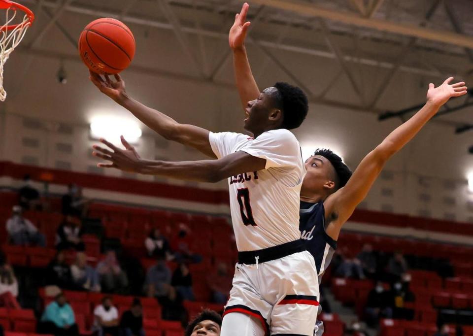 Mansfield Legacy guard Wayne Wiggins (0) goes to the basket for two points against Richland guard Jourdyn Grandberry during the first half of a 5A Region 1 Boys Basketball Area-Round 2 playoff game played on February 24, 2021 at Burleson High School. (Steve Nurenberg Special to the Star-Telegram)