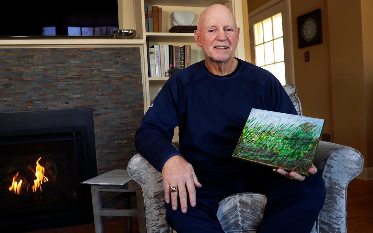 Darryl Johnson, a Vietnam War veteran, is pictured in his home with artwork he created in therapy sessions to help work through post-traumatic stress disorder.