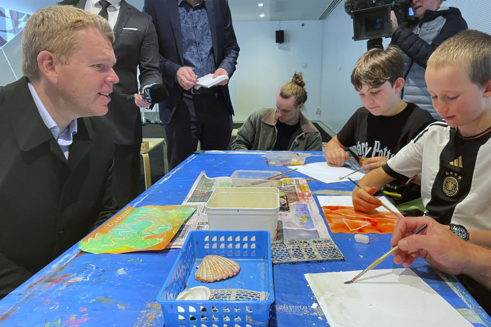 New Zealand's Prime Minister Chris Hipkins, left, inspects children's art works during a campaign stop in New Plymouth on Monday, Sept. 25, 2023. With less than three weeks to go until a general election, opinion polls have put Hipkins and his Labour Party significantly behind the National Party, led by former businessman Christopher Luxon. (AP Photo/Nick Perry)