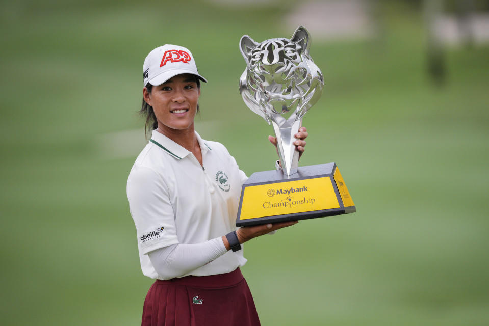 Celine Boutier of France celebrates with the winner's trophy after winning the final round of the LPGA Maybank Championship in Kuala Lumpur, Malaysia, Sunday, Oct. 29, 2023. (AP Photo/Vincent Thian)