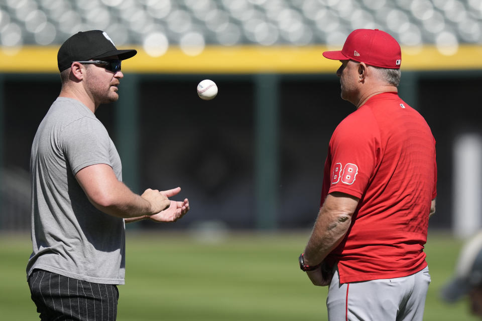 Chicago White Sox pitcher Liam Hendriks, left, talks with Los Angeles Angels manager Phil Nevin before a baseball game Monday, May 29, 2023, in Chicago. The White Sox returned Hendriks from his injury rehabilitation assignment with Triple-A Charlotte and reinstated him from the 15-day injured list Monday. (AP Photo/Charles Rex Arbogast)