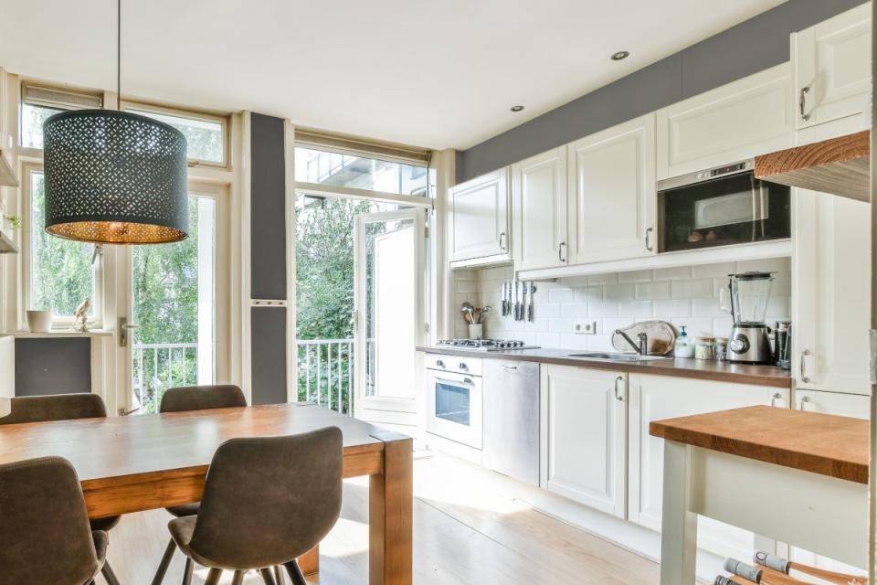 A small kitchen with dark gray wall paint accents.