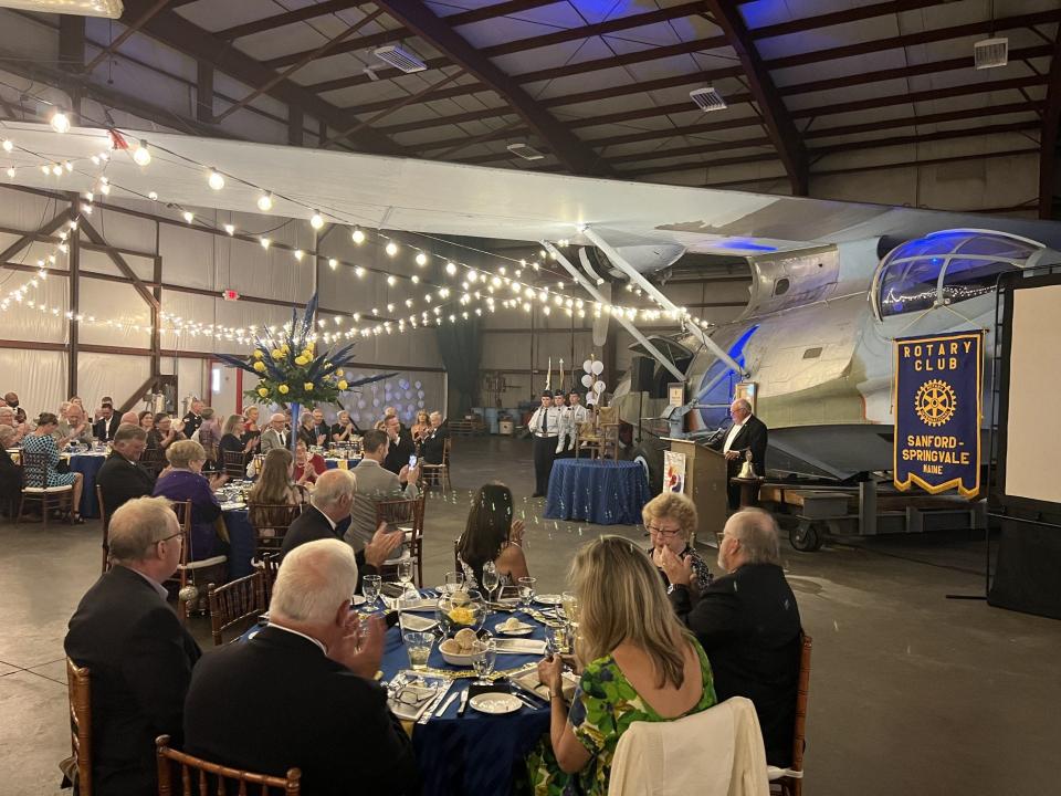 Elias Thomas, the president of the Sanford-Springvale Rotary Club, addresses his fellow Rotarians during the local service organization's centennial celebration in a private hangar at Sanford Seacoast Regional Airport on Sept. 16, 2023.