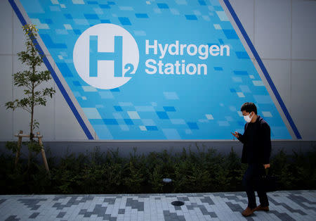 A passerby walks past in front of a hydrogen station in Tokyo, Japan April 24, 2017. REUTERS/Issei Kato