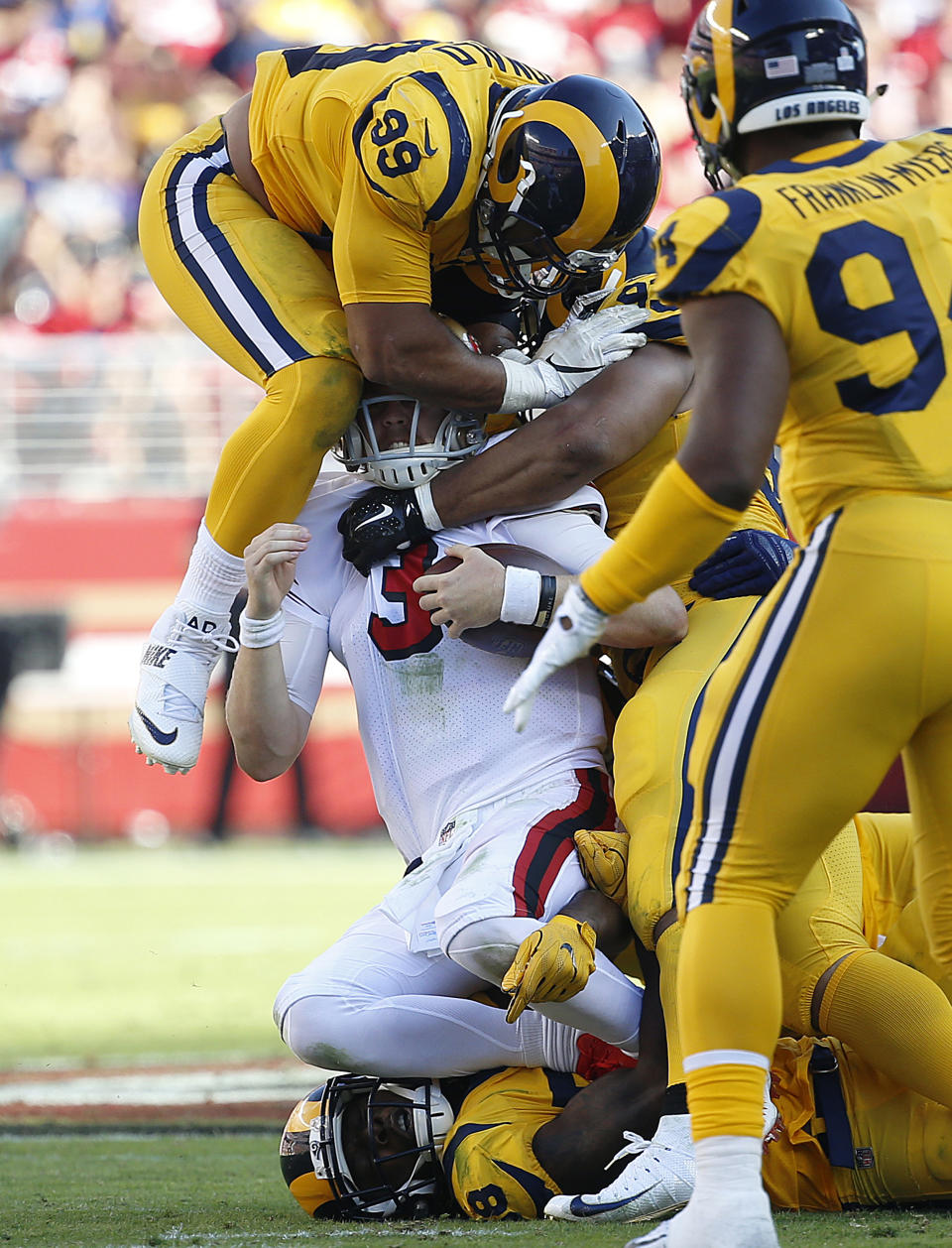 <p>San Francisco 49ers quarterback C.J. Beathard (3) is tackled by Los Angeles Rams defensive tackle Aaron Donald, top, Cory Littleton, bottom, and Ndamukong Suh, second from right, during the second half of an NFL football game in Santa Clara, Calif., Sunday, Oct. 21, 2018. (AP Photo/Josie Lepe) </p>