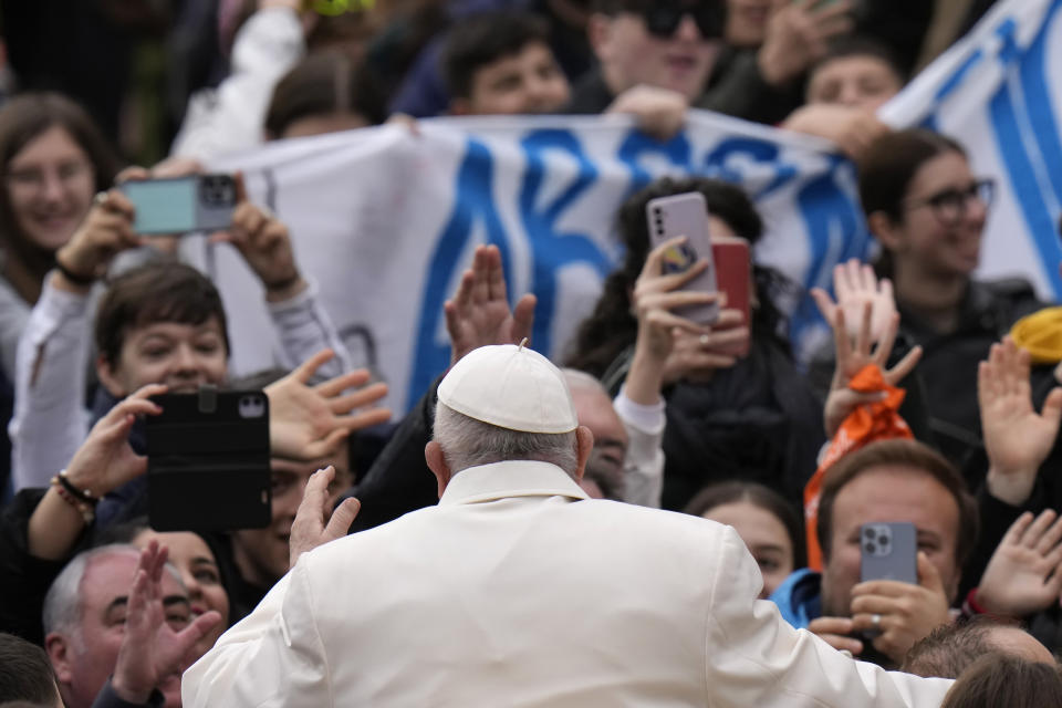 Pope Francis waves faithful as he arrives for his weekly general audience in St. Peter's Square, at the Vatican, Wednesday, April 3, 2024. (AP Photo/Alessandra Tarantino)